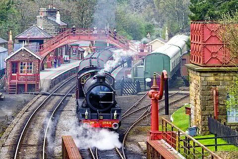 A vintage passenger steam train leaving Goathland Station on the way to Whitby on the North York Moors Railway